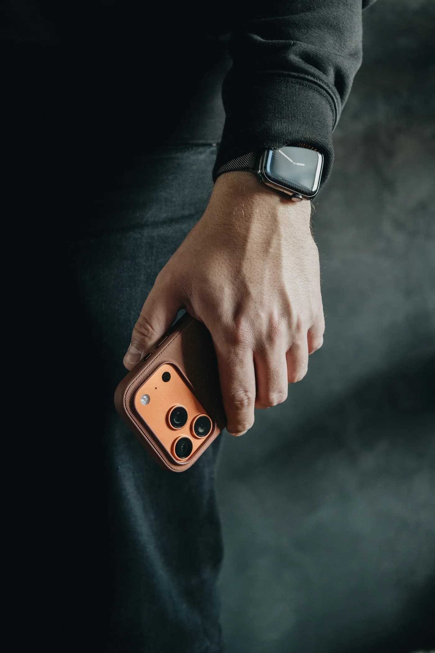 A hand holding a refurbished smartphone